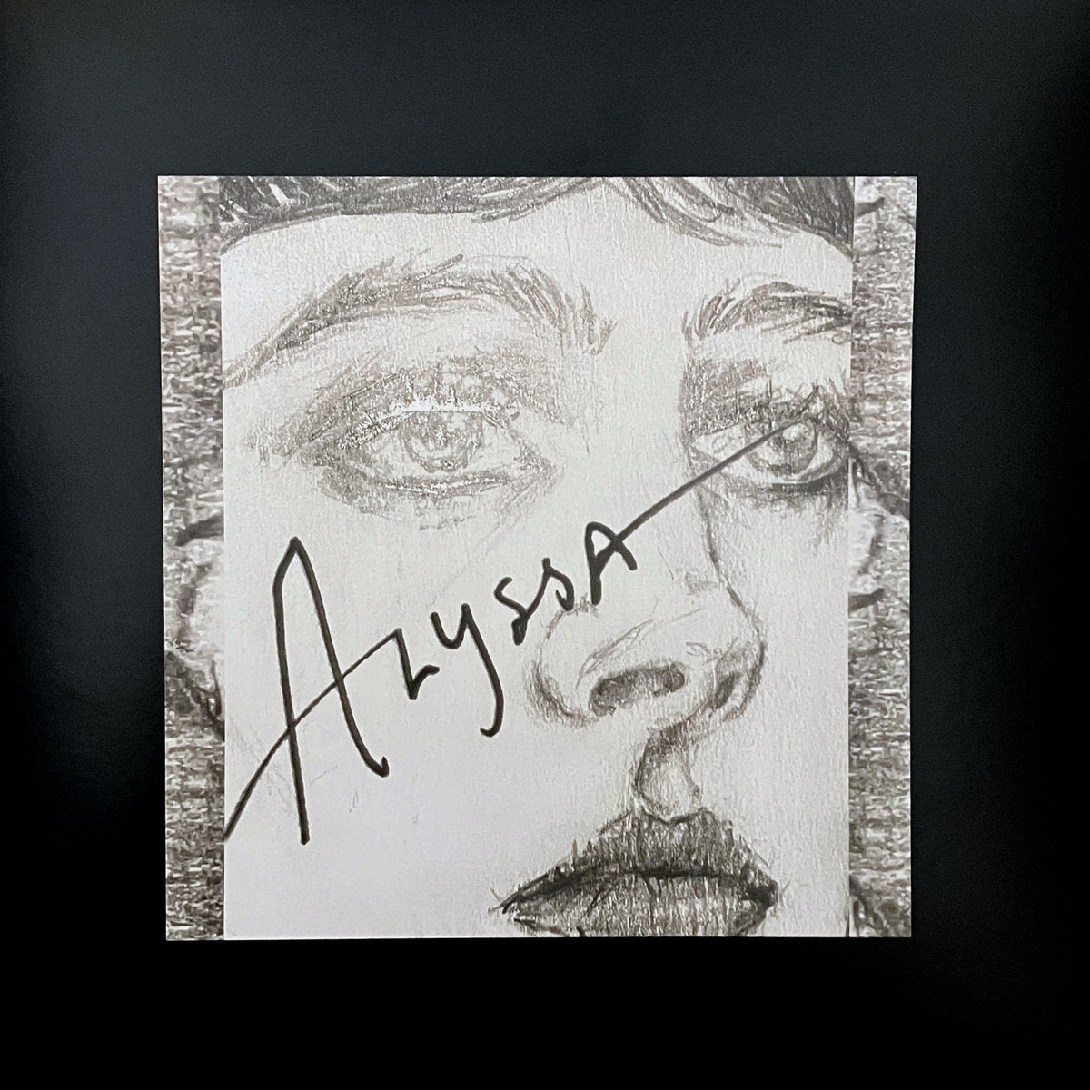 Black and white illustration of a face with the name 'Alyssa' written on it, set against a black background.