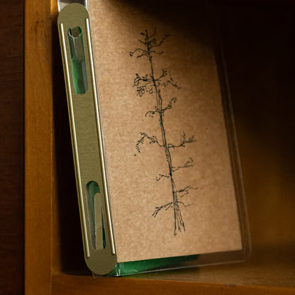Cassette with a tree illustration on a wooden surface